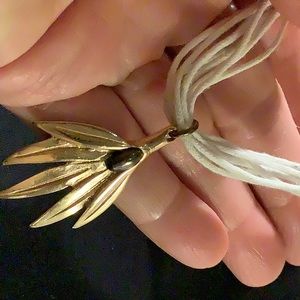 Gold tone olive leaf necklace.